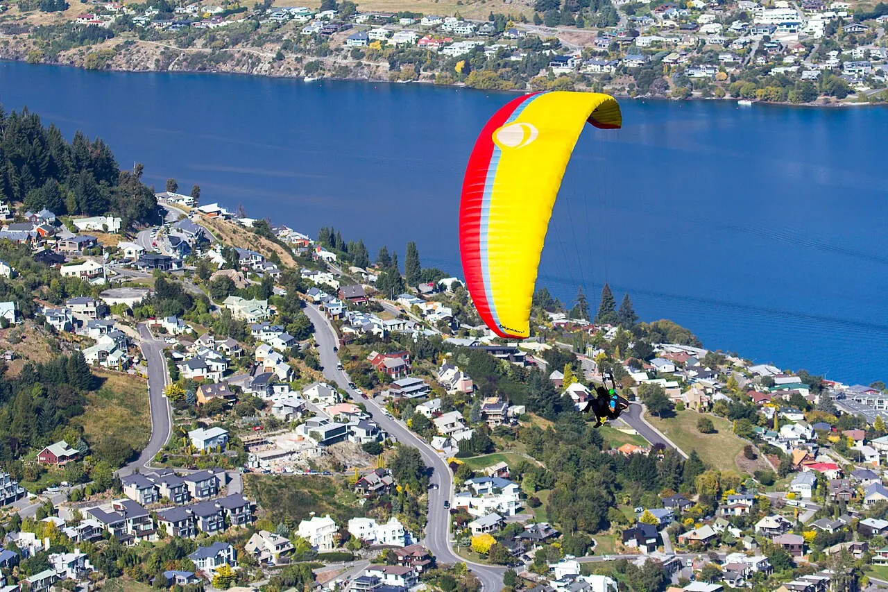 A paraglider above Queenstown and Lake Wakatipu